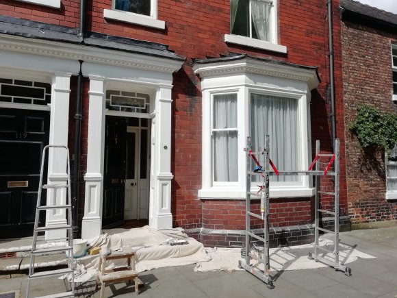 Window and front entrance to town house in Norton.